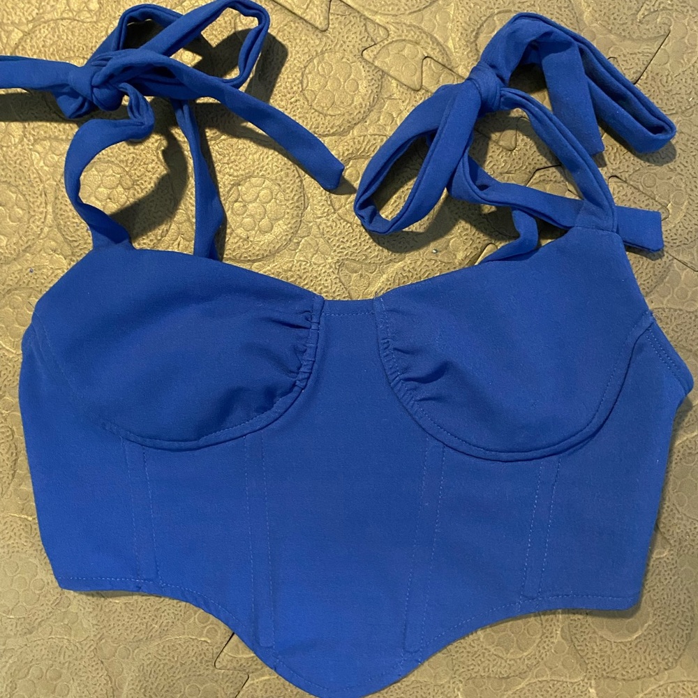 Blue corset top with ties.
